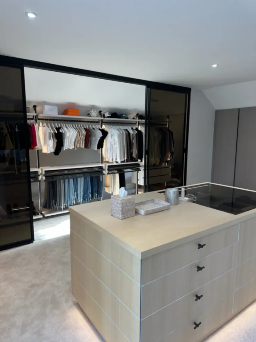 Dressing room with a central island and organised hanging rails