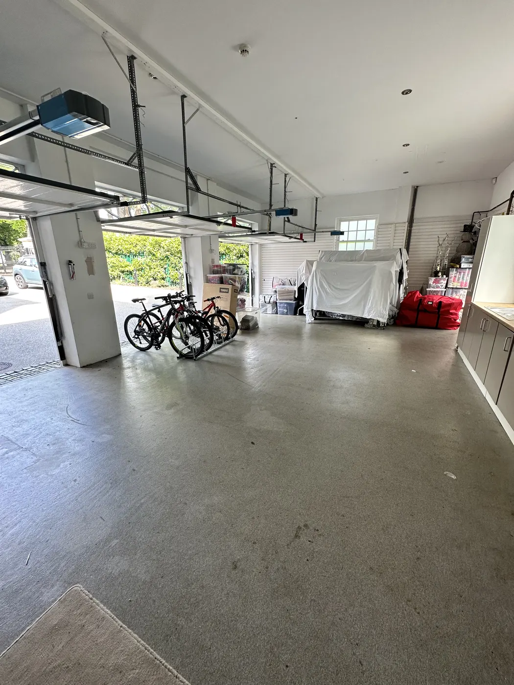 Double garage after: clear floor with bikes and storage lined up at the sides