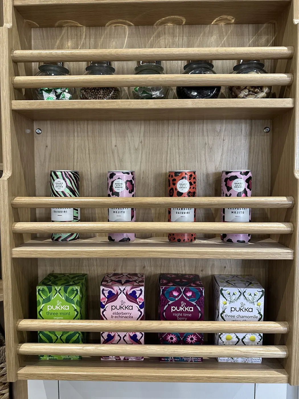 Wall-mounted tea shelf with boxes lined up in neat rows
