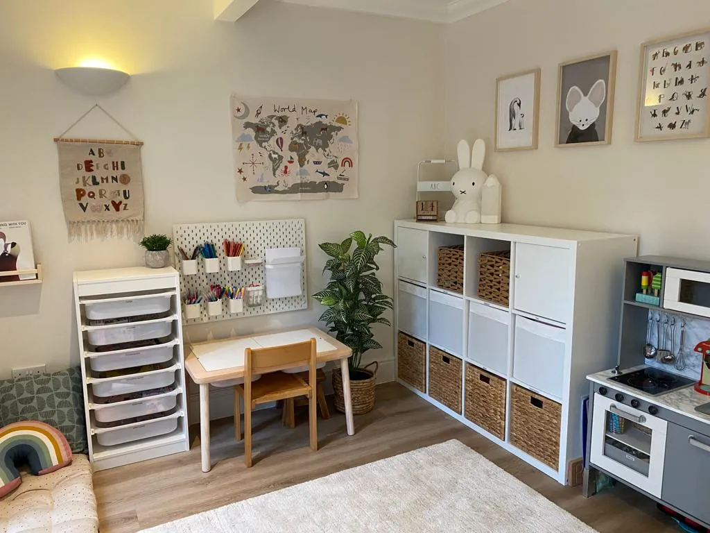Organised playroom with accessible toy baskets and a clear craft desk