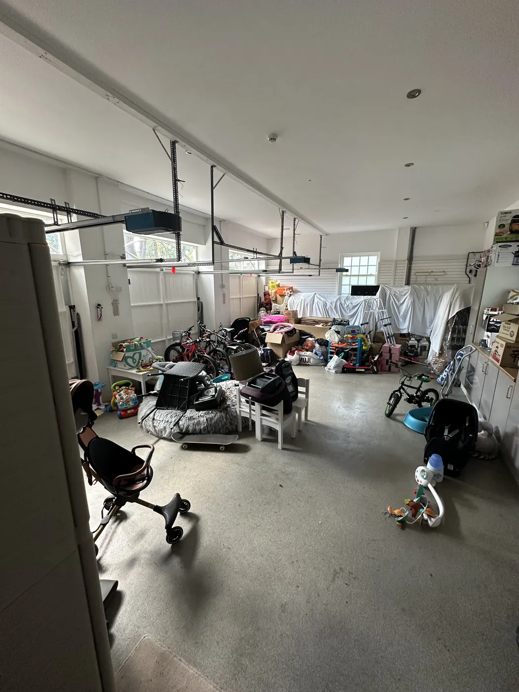 Double garage before: toys, bikes and outdoor kit spread across the floor